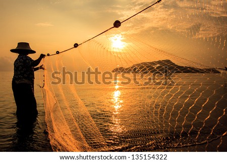 Fisherman at sunset in Thailand