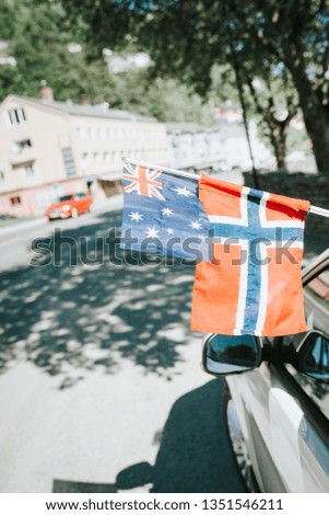 Norwegian and Australian flag on car, summer. Norway