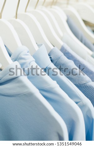 women's blue things hang on hangers in the store.