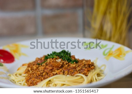 Tasty spaghetti bolognese on kitchen table
