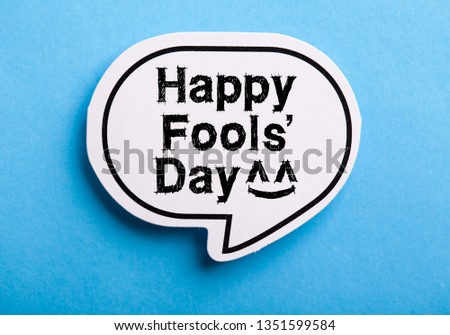 Happy April Fools' Day speech bubble isolated on blue background.