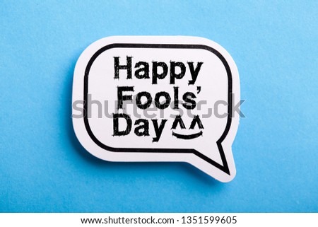 Happy April Fools' Day speech bubble isolated on blue background.