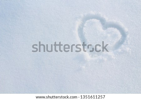 Heart in the snow. Close-up. Background. Texture.