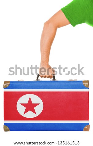 The North Korea flag on a suitcase. Isolated on white.