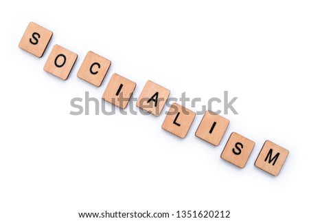 The word SOCIALISM, spelt with wooden letter tiles over a plain white background.