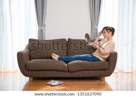 The woman who sits down on a sofa