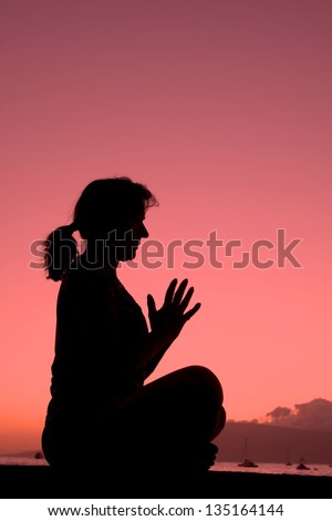 Woman Meditating in the Sunset
