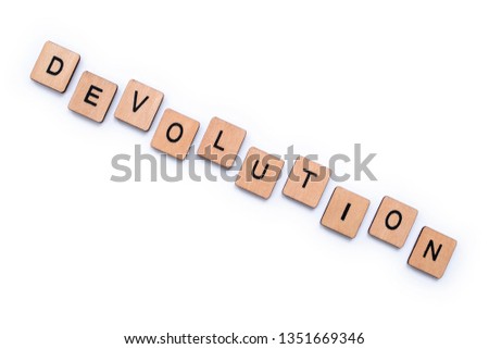 The word DEVOLUTION, spelt with wooden letter tiles over a plain white background.