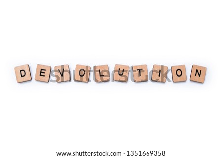 The word DEVOLUTION, spelt with wooden letter tiles over a plain white background.