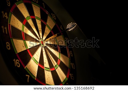 darts arrows in the target center Royalty-Free Stock Photo #135168692