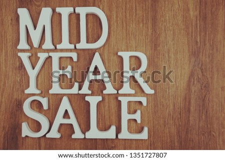 Mid Year Sale alphabet letters on wooden background business concept