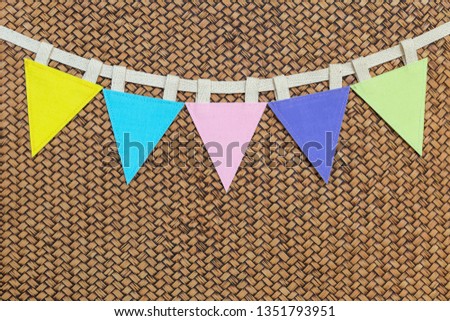 Color triangle fabric flag on wood pattern background, bunting party flag on blank bamboo pattern background
