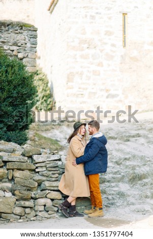 A beautiful couple travels to the sights of Georgia. Love story in nature with the fortress.