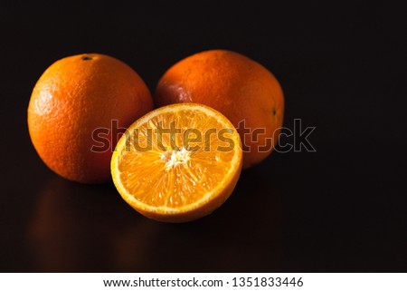 Fresh fruit oranges on black wooden background 