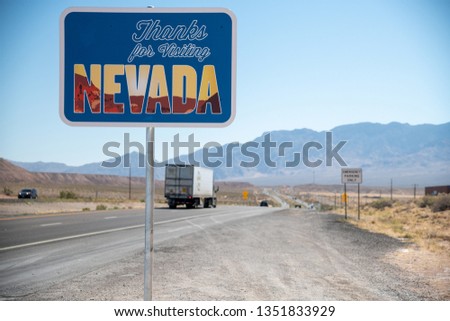 Welcome to Nevada road sign along State Route, USA.