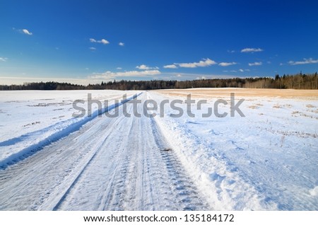 classic winter scene of a road in rural area
