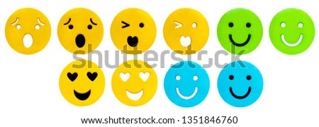 Colorful sewing buttons in emotional faces isolated on white background.