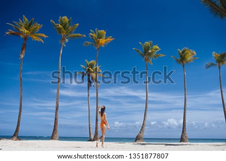 Tall palms and slim woman  
