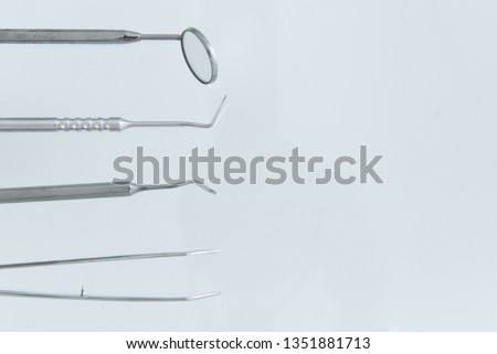 Basic dental instruments for dental examination on a white background. With copy space