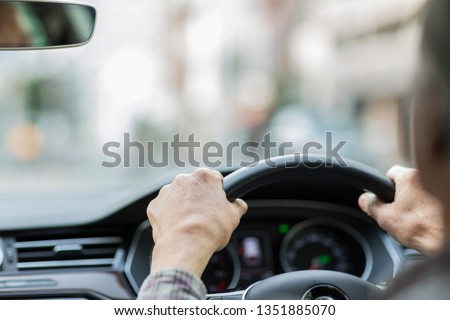 Senior man driving a car Royalty-Free Stock Photo #1351885070