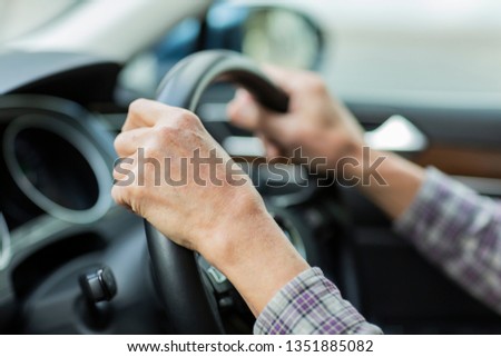 Senior man driving a car Royalty-Free Stock Photo #1351885082