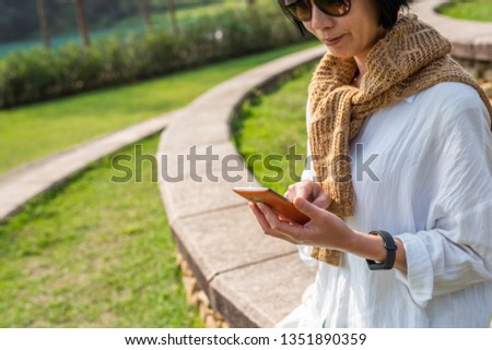 woman using mobile at the outdoor, concept of technology, lifestyle, leisure