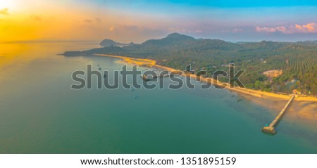 aerial view sunrise at pier of Phayam temple one landmark of Phayam island. Phayam temple is on Hin Kao gulf. 
The temple is close to the shipping port. in the end of Phayam temple pier have memorial 