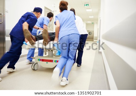 Rear view of doctors running for the surgery  Royalty-Free Stock Photo #1351902701