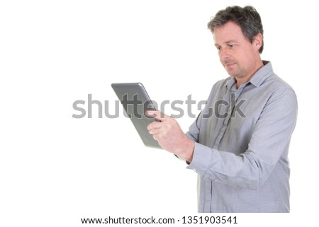 Smiling man playing on digital tablet on white background