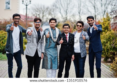 Group of six south asian indian mans in traditional, casual and business wear standing and  shows thumb up.