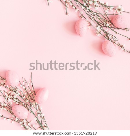 Easter composition. Easter eggs, white flowers on pastel pink background. Flat lay, top view, copy space, square