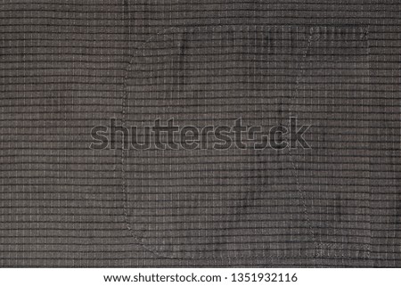 Background, texture of old cotton fabric in a cage with a sewn pocket.