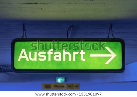 Old and Dirty Exit Sign in a Parking Garage in Berlin 