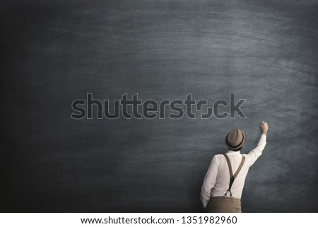 wise man start writing on a empty blackboard Royalty-Free Stock Photo #1351982960