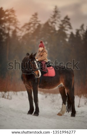 Little girl with horse outdoor portrait at spring day
