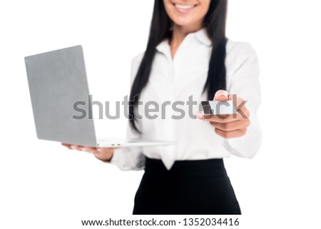 Cropped view of elegant businesswoman in glasses holding laptop and credit card isolated on white