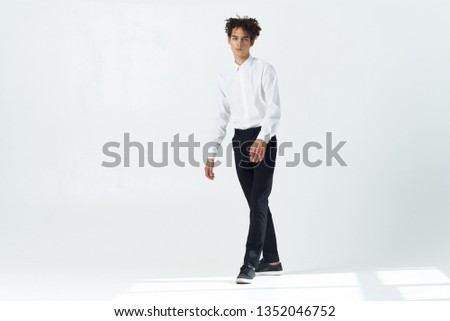 handsome curly guy in a white shirt office worker
