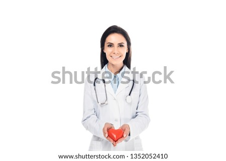 Doctor in white coat holding plastic heart isolated on white
