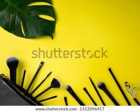 Concept summer sale, flat lay Bag with makeup brushes, cosmetics, yellow background, Empty space for design