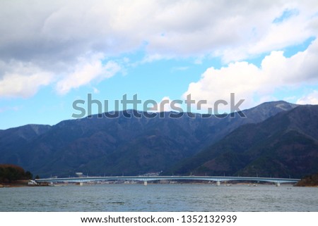 Kawaguchi lake surrounded by mountains and the bridge over the lake.