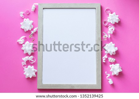celebration White photo frame on pink background, birhday concept . white flowers and tape.