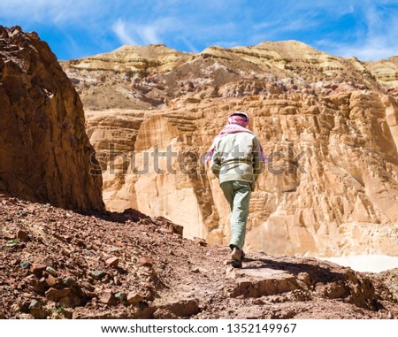 Bedouin climbs a mountain in a canyon in Egypt Dahab