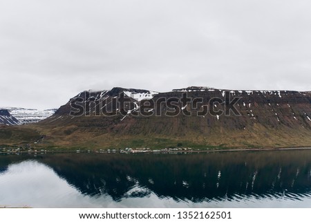 The lake is between the black mountains. Lake and mountains and Iceland