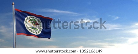 Flag of Belize rise waving to the wind with sky in the background