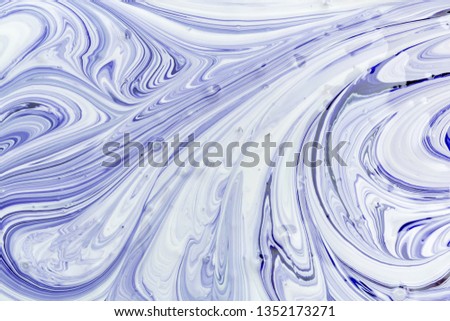 The process of mixing white and blue paint close-up. Empty abstract background for layouts.