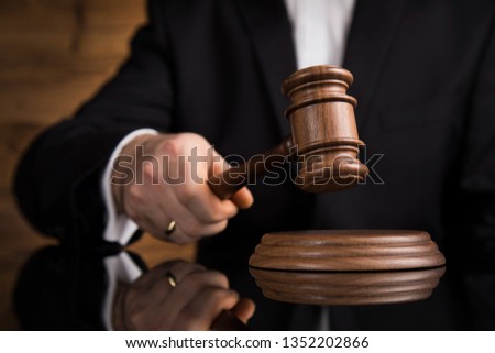Justice and law concept, Male judge in a courtroom striking the gavel