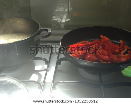 red fresh bell pepper chopped stew in a kitchen pan, on a gas stove vegetarian healthy wholesome homemade food, spring and summer menu
