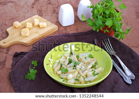 Roasted Jerusalem artichoke with cheese and parsley on a green plate. Healthy food