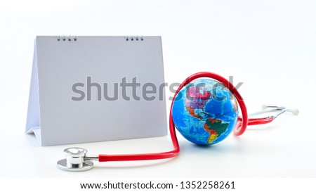 Red stethoscope with Empty calendar and globe on white background. Copy space. Healthcare. World Health Day 7 April