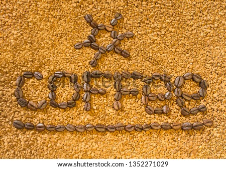 the word coffee from the coffee beans on the background of scattered instant coffee